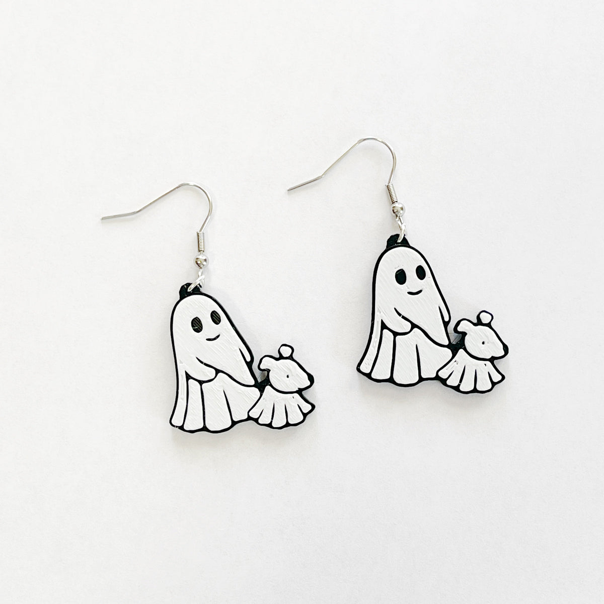 ghost walking a ghost dog, black and white dangly earrings