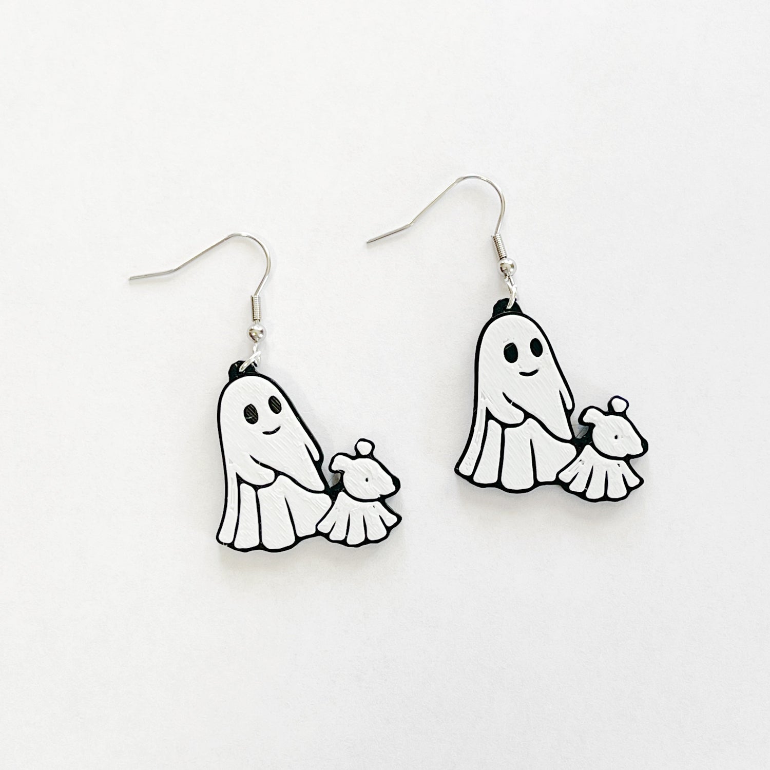 ghost walking a ghost dog, black and white dangly earrings