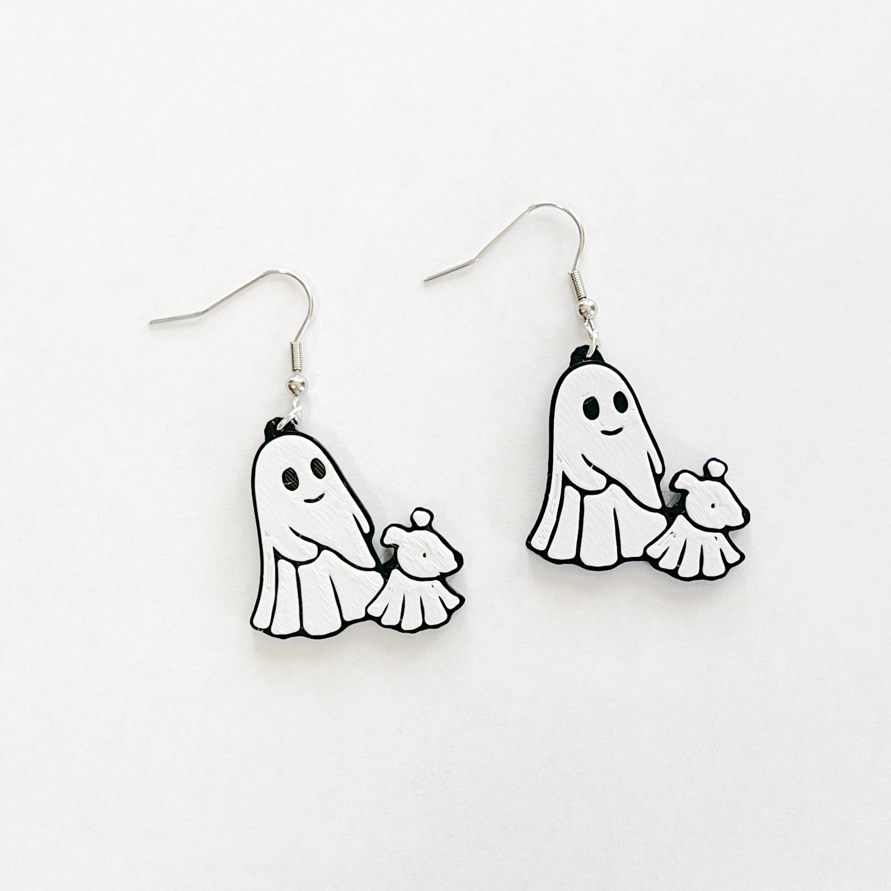 ghost walking a ghost dog, black and white dangly earrings